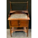 A late Victorian mahogany wash stand, the top inset with a fossil stone/marble surface, above a pair