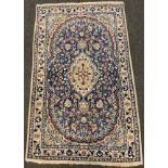 A Persian, hand-made Nain rug / carpet, the central lozenge-shaped field woven profusely with