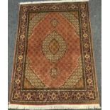 A fine Persian, hand-made, Tabriz rug / carpet, woven with stylised floral motifs in shades of