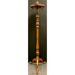 A late 19th/early 20th century mahogany revolving coat and hat stand, urn finial above revolving