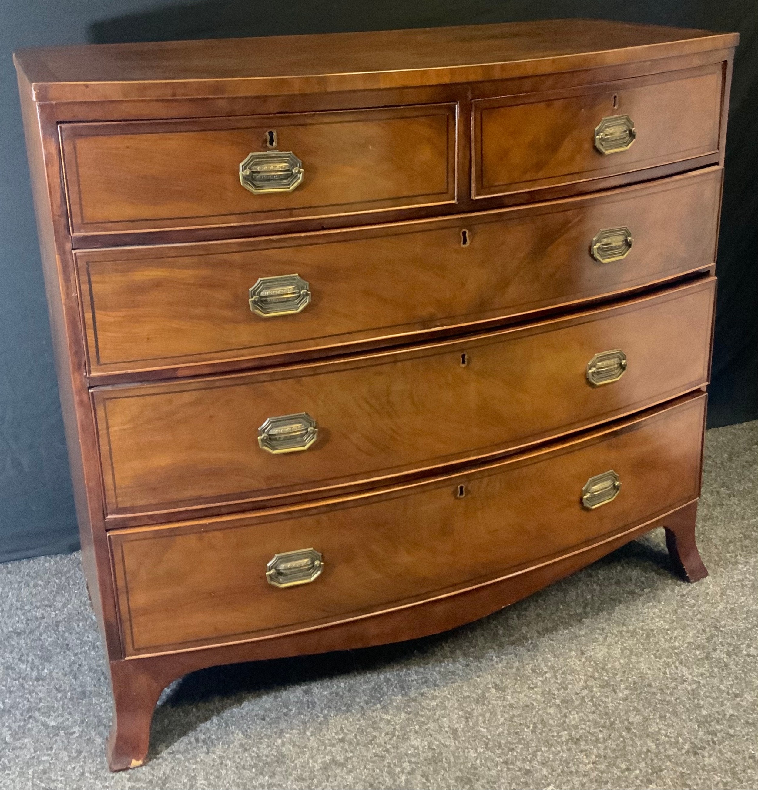 A Victorian mahogany bow-front chest of drawers, two short and three long graduated cockbeaded