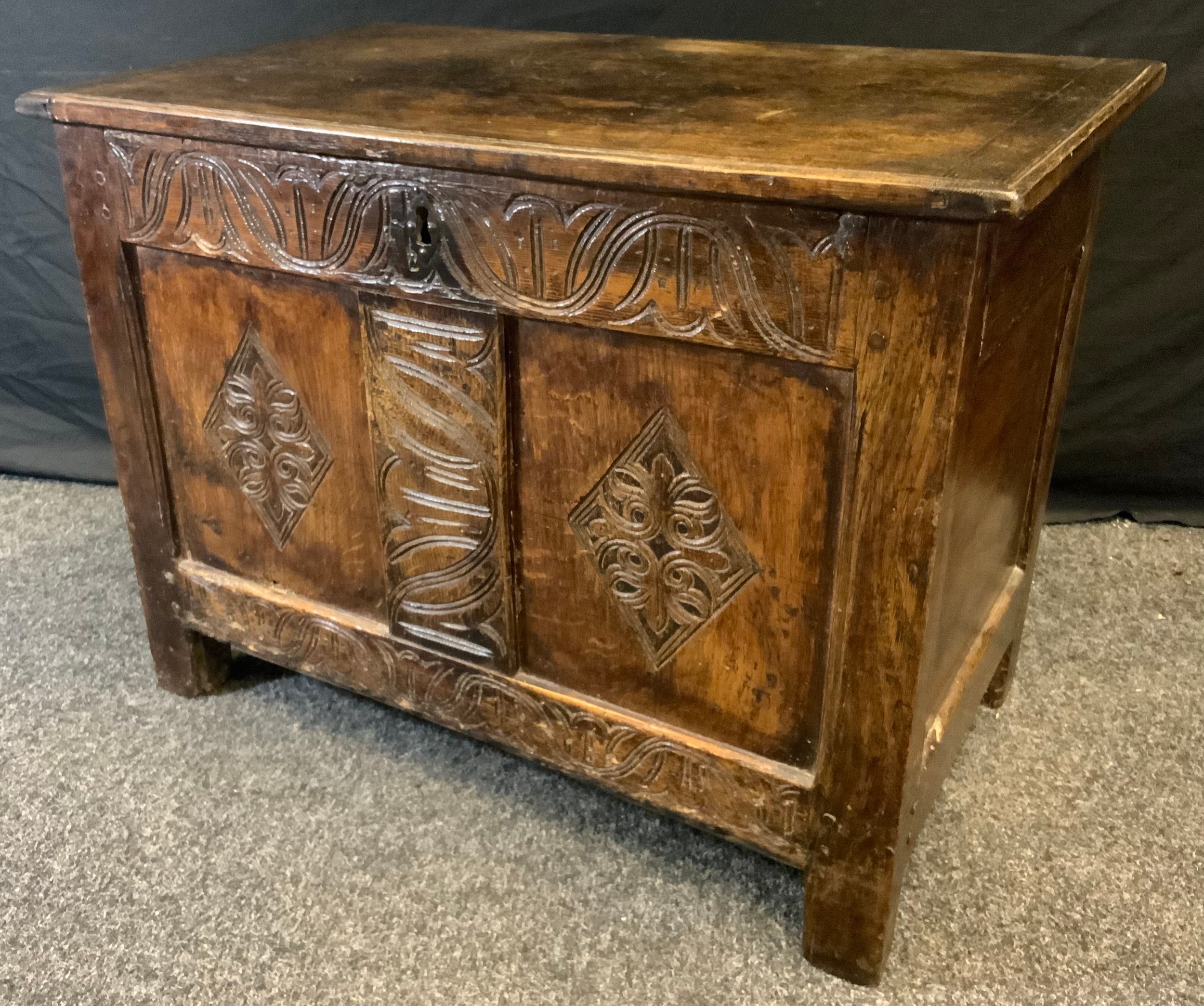 A 18/early 19th century oak blanket chest, hinged top, two paneled carved front, 56cm high, 76cm