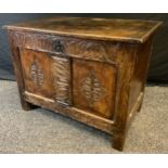 A 18/early 19th century oak blanket chest, hinged top, two paneled carved front, 56cm high, 76cm