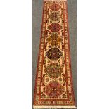 A fine, hand-made Behbahan runner carpet, 305cm x 77cm.