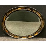 A late 19th/early 20th century chinoiserie oval wall mirror, decorated with pagodas and flying