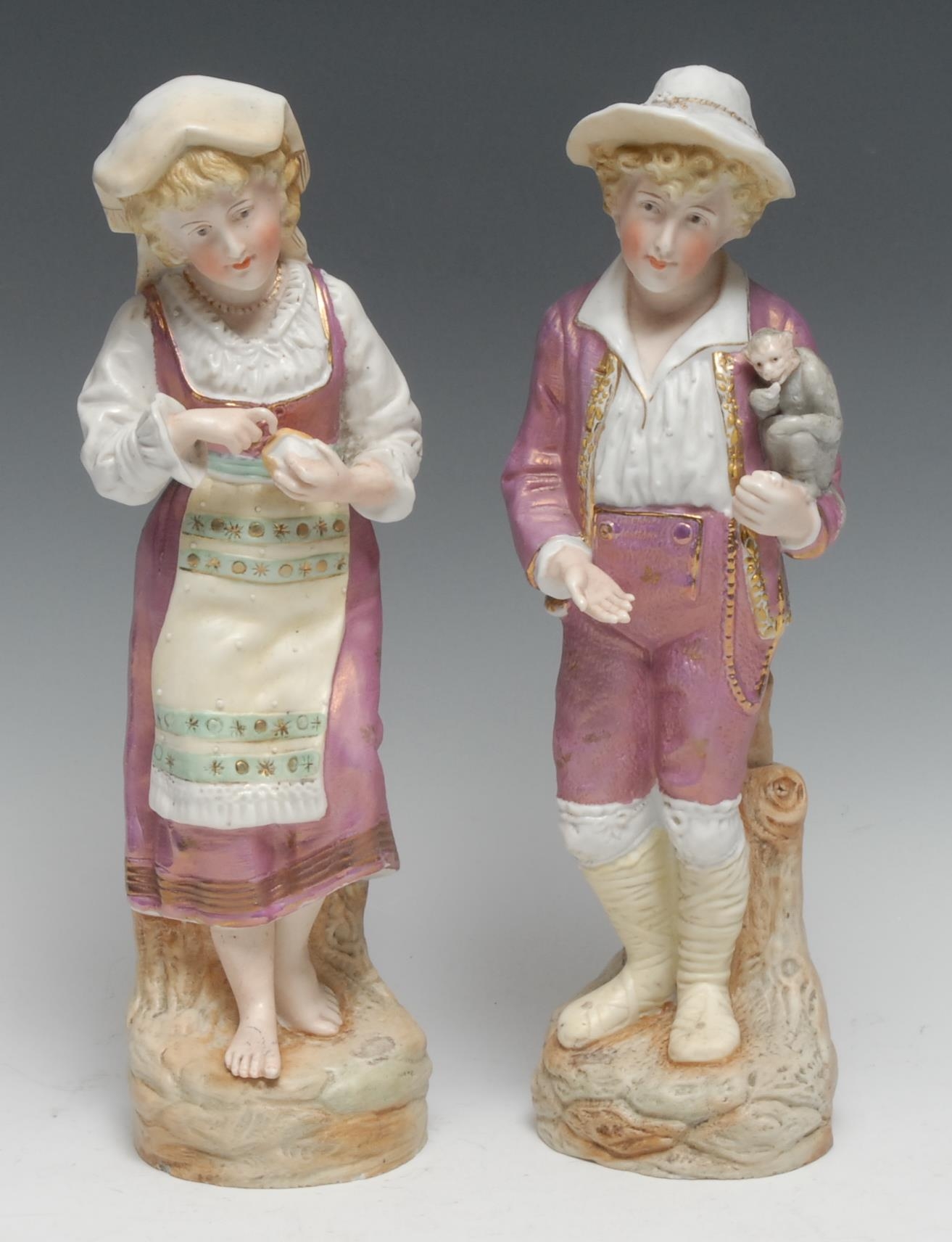 A pair of Continental bisque figures, of a boy with a monkey, his companion peeling an orange,