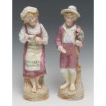 A pair of Continental bisque figures, of a boy with a monkey, his companion peeling an orange,