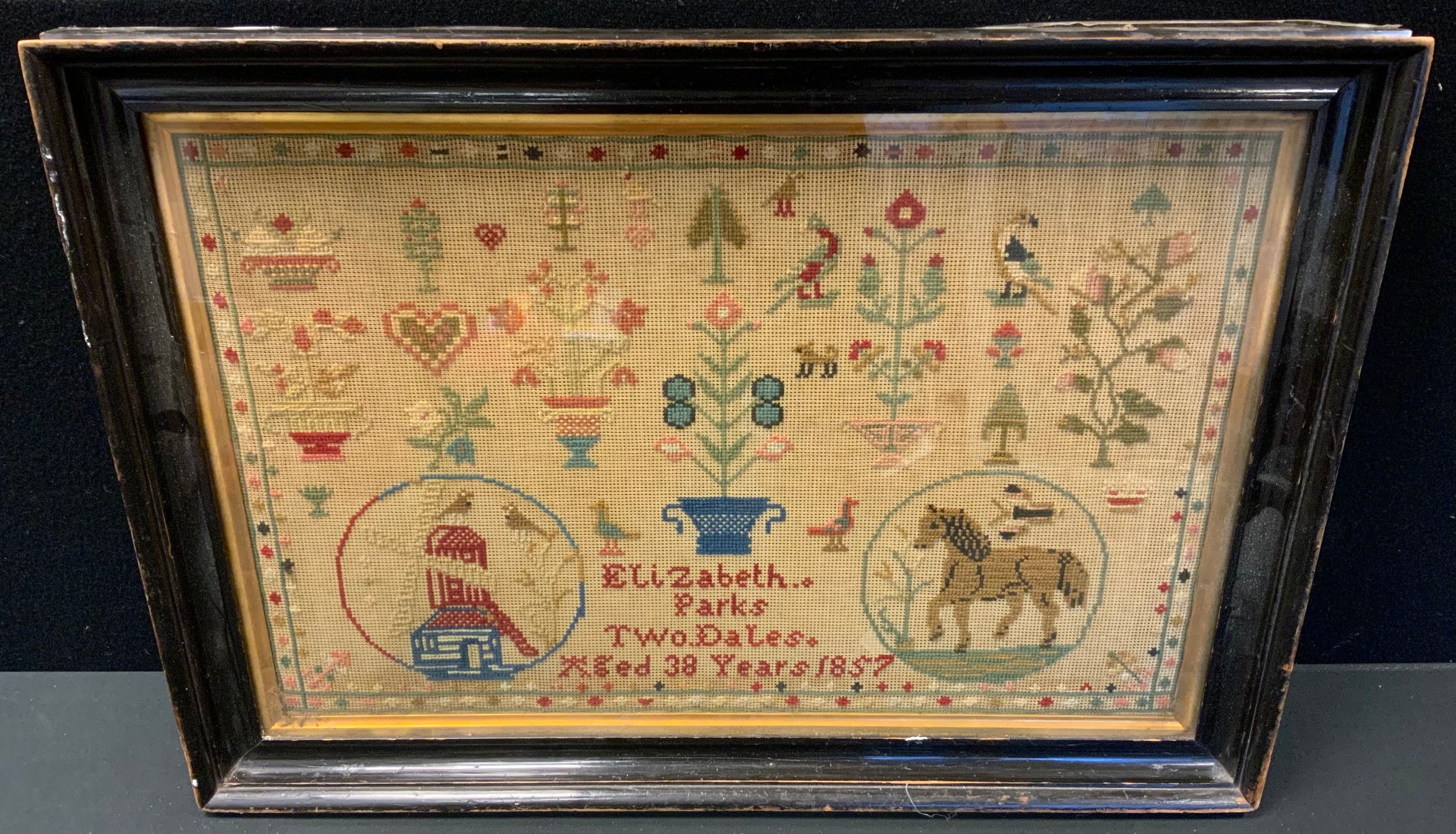 A mid 19th century needlework sampler, embroidered by Elizabeth Parks, Two Dales, aged 38 years,