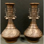 A pair of Meiji period Japanese bronze vases, flared top with cloud and ring neck, Birds of paradise