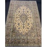 A fine Kashan rug / carpet, woven in muted tones of grey, blue, and cream, 310cm x 205cm.