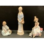 A Lladro figure, of a girl with cat and dog, 5640; a Lladro figure, of a girl on a telephone,
