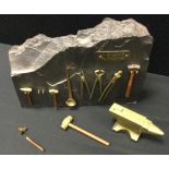 A miniature brass anvil and tool set, This England, My England inc sledgehammer, tongs. smelting