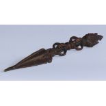 A Tibetan Buddhist bronze phurba, the pommel cast with the three faces of Vajrak?la, 23.5cm long,