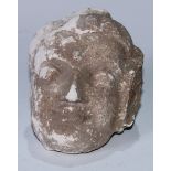 An Indian sandstone sculptural fragment, carved as the head of a female deity, 13cm high, 19th