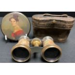 A Regency papier-mache circular snuff box and cover, painted with a young lady in profile, 8.5cm