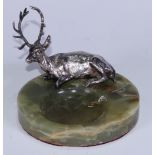 An Art Deco period desk tidy, the green onyx dish applied with a silvered model of a recumbent stag,