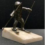 Continental School (early 20th century), a dark patinated bronze, of a child skiing, marble faux