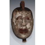 Tribal Art - a West African mask, bird cresting, stylised features picked out with red and white