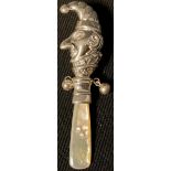 A silver baby's rattle, as Mr Punch