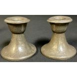 Liberty & Co - a pair of Tudric pewter candlesticks, design no.01417, c.1910