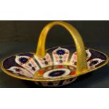 A Royal Crown Derby Imari palette 1128 pattern basket, the handle painted in solid gold, 28.5cm