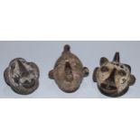 Tribal Art - a Baule terracotta mask, bird cresting, extensively scarified features, pused lips,