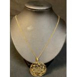 An 18ct gold necklace with circular 18ct gold pendant, applied with illusory white gold faceted