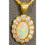 An 18ct gold necklace suspended with an 18ct gold opal polished cabochon pendant, the opal