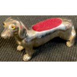 A silver novelty pin cushion, as a dachshund