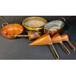 A graduated set of three conical copper grain scoops; a 19th century copper fish kettle; another two