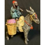 A cold painted metal novelty pin cushion, as an Arab on a donkey