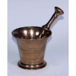 A bronze pestle and mortar, the flared cylindrical mortar ring-incised, 10.5cm high, 12.5cm