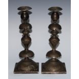 Judaica - a pair of Jewish silvered metal Shabbat Sabbath candlesticks, knopped pillars, chased with