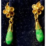 A pair of gold and polished jade droplet earrings, rope twist flower head terminals, unmarked,