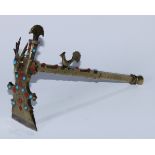 A Tibetan brass ceremonial adze, steel blade, deer and peacock crestings, applied with coral and