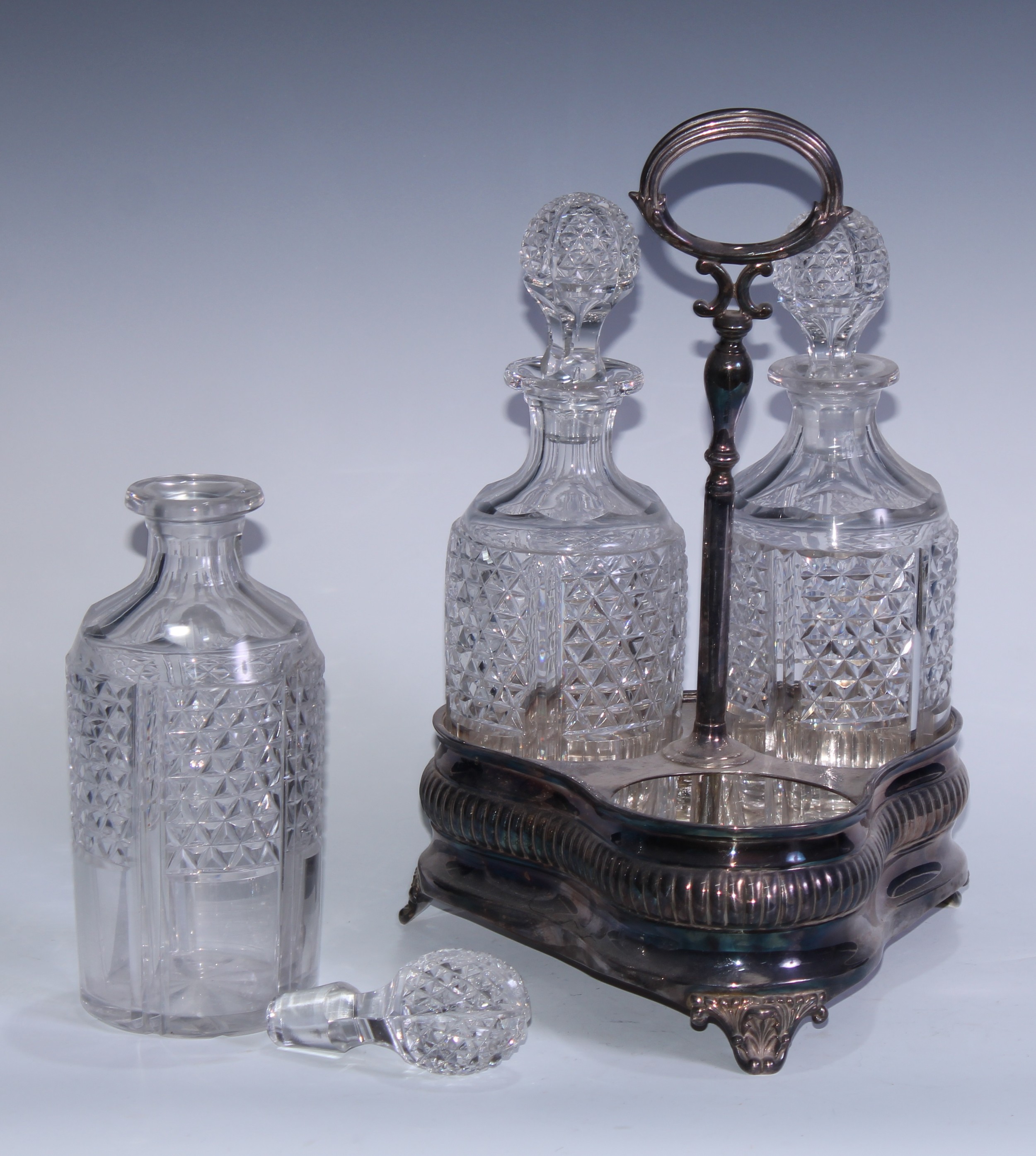 An Adam Revival EPNS and cut-glass three-bottle decanter stand, the trefoil-shaped base engraved - Image 3 of 3