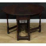 An 18th century oak gateleg table, near-circular top with fall leaves above a frieze drawer,