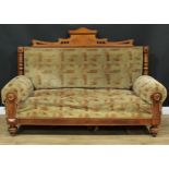 A late Victorian Eastlake style sofa, rectangular back crested by a shaped pediment incised with a