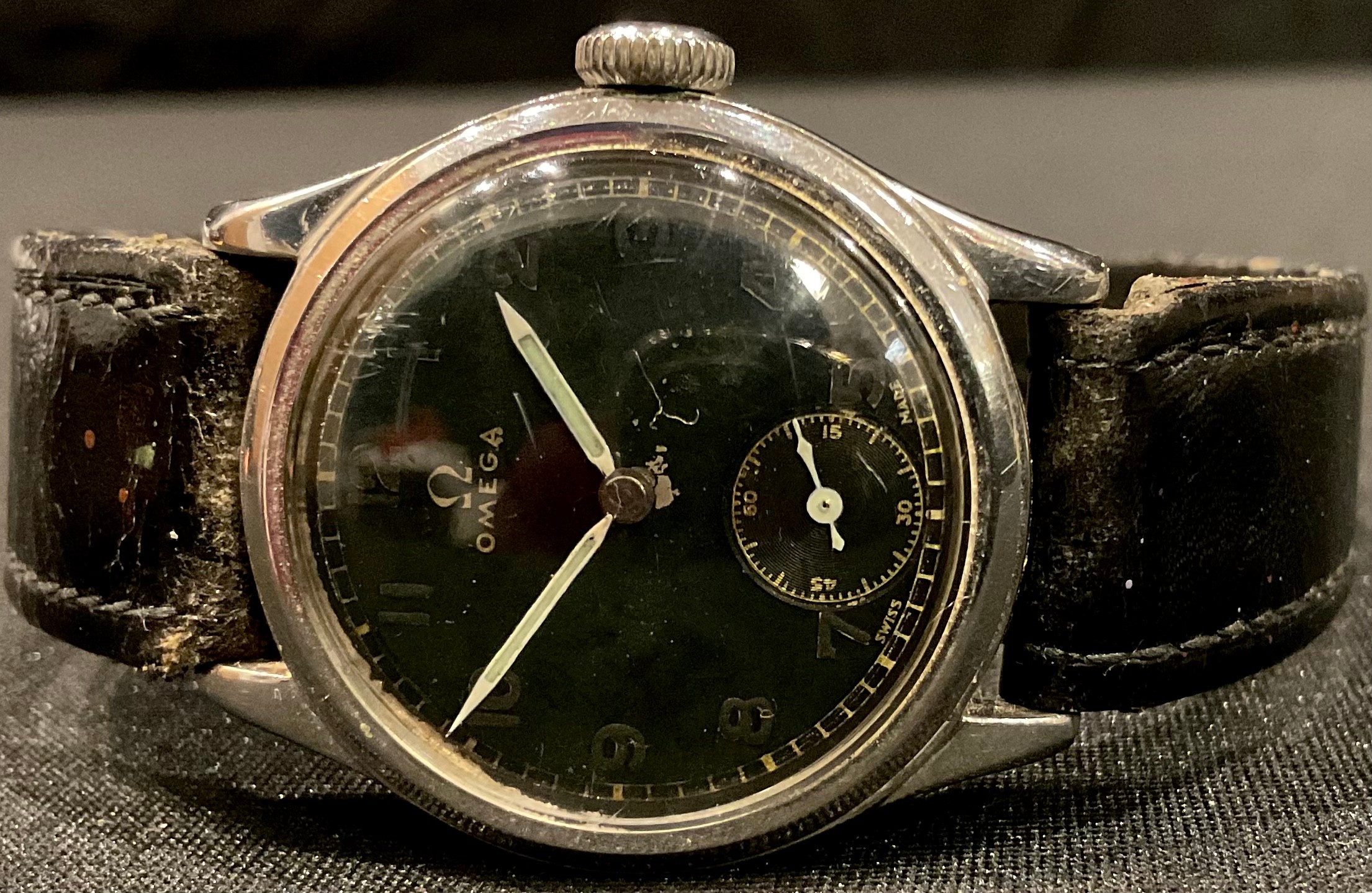 A vintage Omega black faced military wristwatch