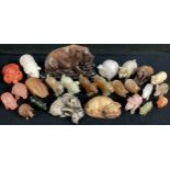 A collection of hardstone pigs, including alabaster, jadite, malachite, soap stone, ste