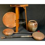 A rustic yew kitchen bar stool, saddle seat, iron ring stretcher; a Persian circular copper tray,