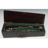A 19th century EPNS-mounted rosewood four-section clarinet, 65cm long, green baize-lined mahogany
