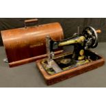 An oak cased Singer manual sewing machine