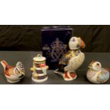 A Royal Crown Derby paperweight, Puffin, gold stopper, boxed; a Collector's Guild Duckling; a