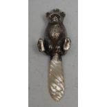 A novelty silver and mother-of-pearl baby's rattle, as bear, 12cm long, apparently unmarked, 20th