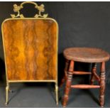 An early 20th century kitchen stool, turned legs; a brass and walnut fire screen, 84cm high (2)