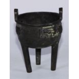 A Chinese bronze tripod censer, cast in the Archaic manner with a band of taotie and scrolls,