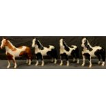 A Beswick model of a Chestnut Skewbald Pony, gloss glaze; three other Beswick Piebald Ponies,