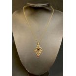 A late 19th/early 20th century 9ct gold seed pearl and garnet openwork pendant with droplet, 9ct