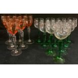 A set of six wine glasses, rose bowls, twisted clear glass stems, 21cm high; a set of eight wine
